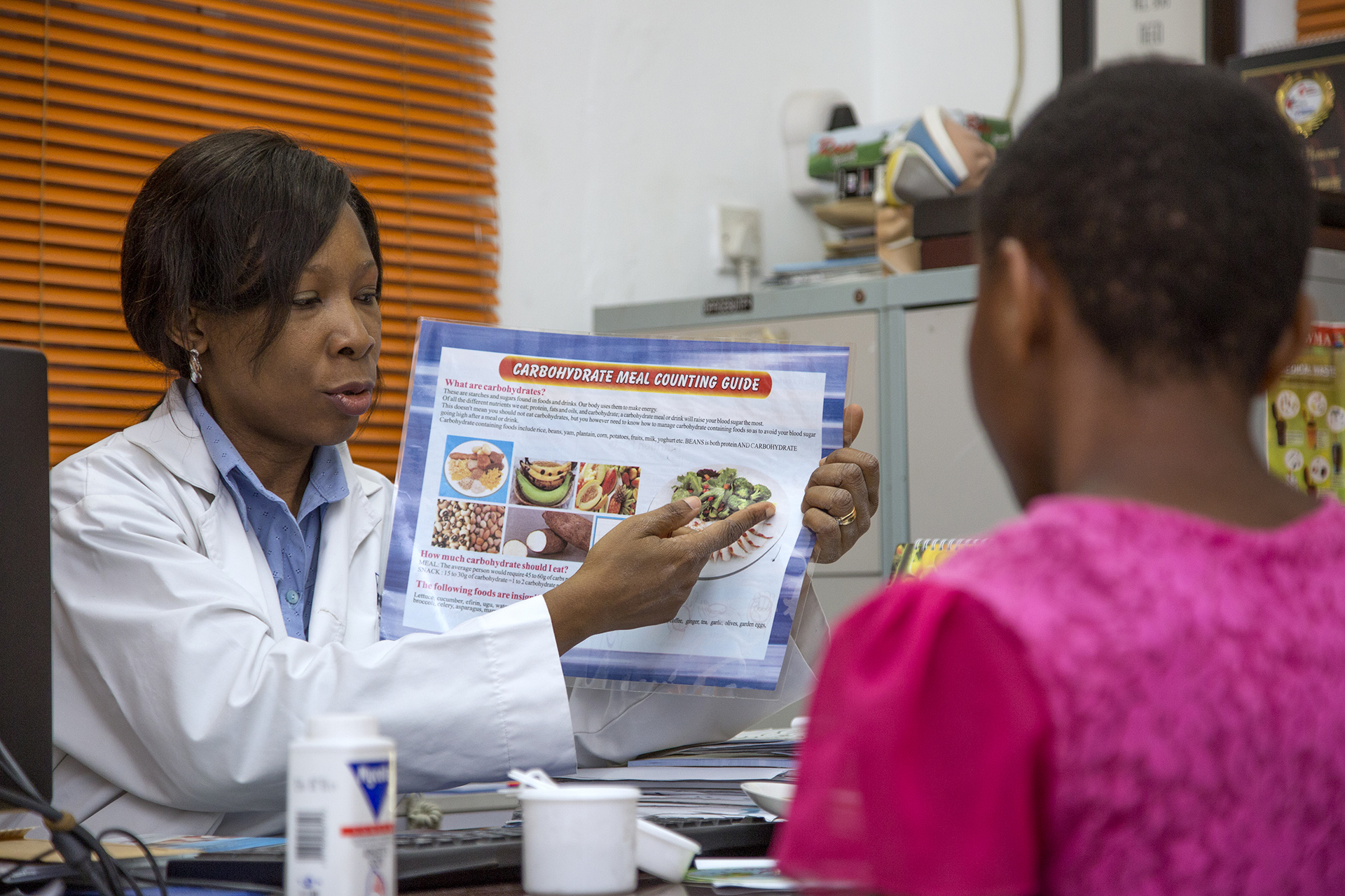 who-060984 A doctor showing a patient an image